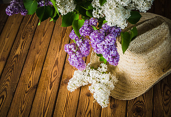 Image showing Still-life with a bouquet of lilacs and a straw hat, close-up