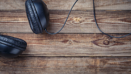 Image showing Headphones over wooden table.