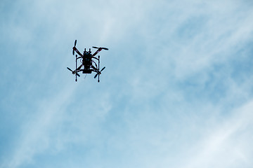 Image showing flying drone with camera on the sky