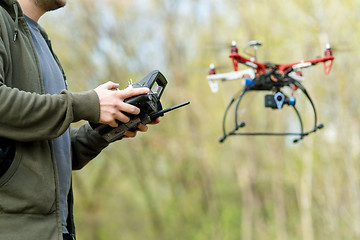 Image showing Man controling a drone.