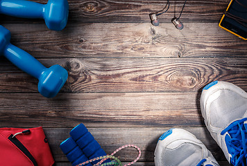 Image showing Sport stuff on wooden table, top view