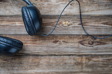 Image showing Headphones over wooden table.