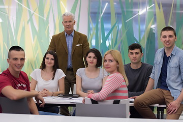 Image showing portrait of  teacher with students group in background