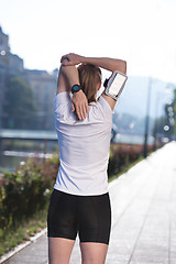 Image showing blonde woman  stretching before morning jogging