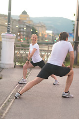 Image showing couple warming up before jogging