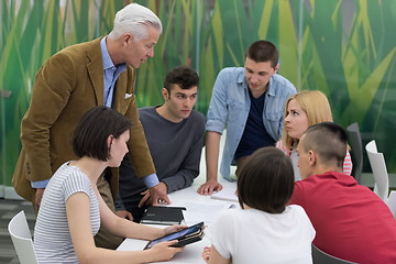 Image showing teacher with a group of students in classroom