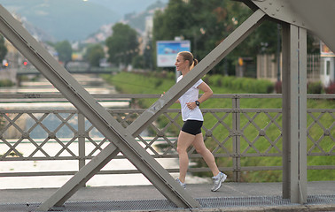 Image showing sporty woman running  on sidewalk