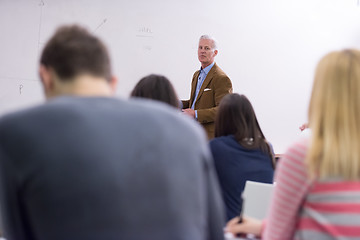 Image showing teacher with a group of students in classroom