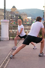 Image showing couple warming up before jogging