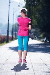 Image showing sporty woman running  on sidewalk