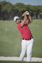 Image showing golfer hitting a sand bunker shot