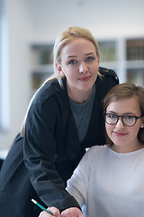 Image showing female teacher helping students on class