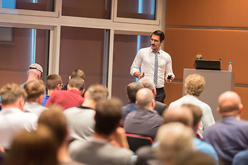 Image showing Business speaker giving a talk in conference hall.