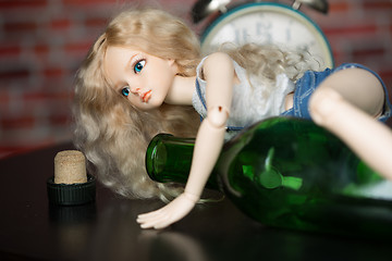 Image showing doll with a bottle. the concept of alcoholism