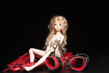 Image showing concept. Doll with different sex toys.