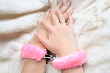 Image showing Male and female hands in handcuffs. sexy couple in bed. sex Toys