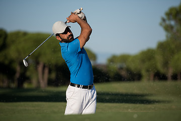 Image showing pro golfer hitting a sand bunker shot