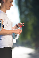 Image showing woman drinking  water after  jogging