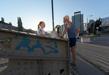 Image showing jogging couple planning running route  and setting music