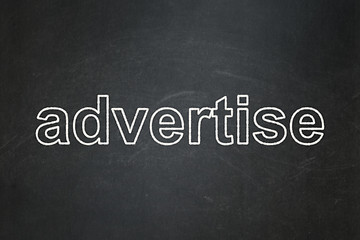 Image showing Advertising concept: Advertise on chalkboard background