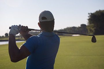 Image showing golf player hitting shot