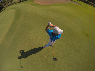 Image showing top view of golf player hitting shot