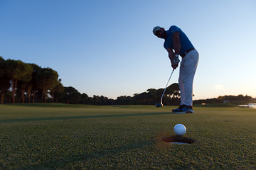 Image showing golfer  hitting shot at golf course