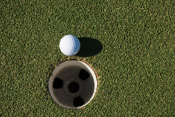 Image showing top view of golf ball in the hole