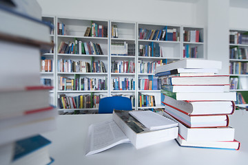 Image showing female student study in library, using tablet and searching for 