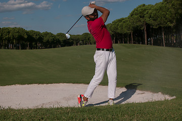 Image showing golfer hitting a sand bunker shot