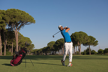 Image showing golf player hitting shot