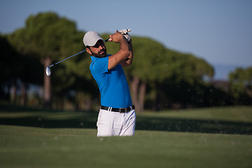 Image showing pro golfer hitting a sand bunker shot