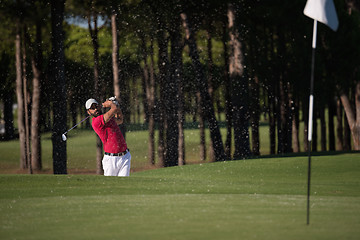 Image showing golfer hitting a sand bunker shot