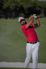 Image showing golfer hitting a sand bunker shot