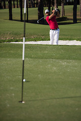 Image showing golfer hitting a sand bunker shot