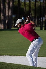 Image showing golfer hitting a sand bunker shot