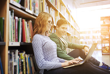 Image showing happy students with laptop in library