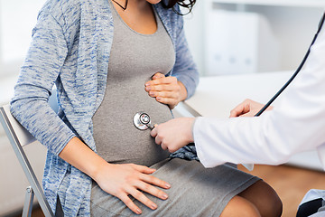 Image showing doctor with stethoscope and pregnant woman belly
