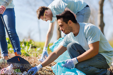 Image showing volunteers with garbage bags cleaning park area