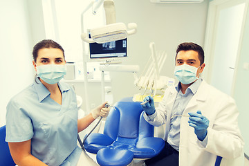 Image showing close up of dentist and assistant at dental clinic