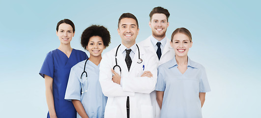 Image showing group of happy doctors over blue background