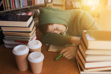 Image showing tired student or man with books in library