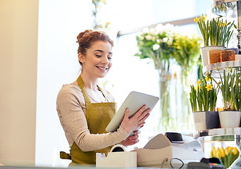 Image showing woman with tablet pc computer at flower shop