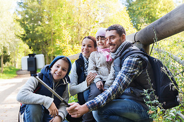 Image showing family with backpacks taking selfie and hiking