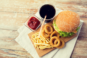 Image showing close up of fast food snacks and drink on table