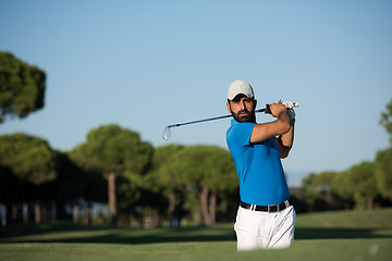 Image showing pro golfer hitting a sand bunker shot