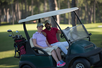 Image showing couple in buggy on golf course