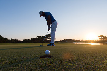 Image showing golfer  hitting shot at golf course