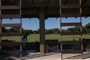 Image showing golf player practicing shot on training