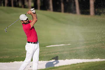 Image showing golfer hitting a sand bunker shot